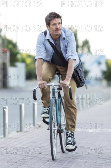 Portrait man riding bicycle city