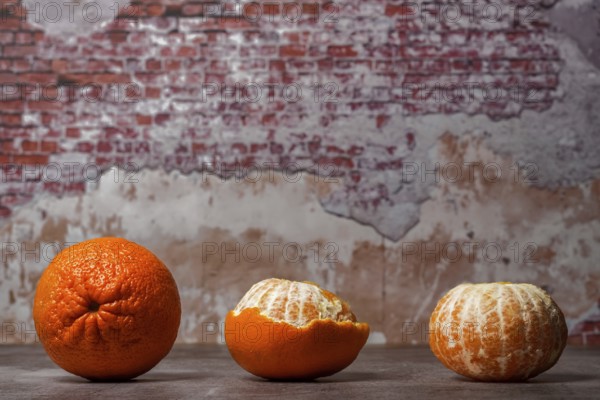 Close-up of whole, peeled tangerines (oranges) (mandarins) (clementines) (citrus fruits) on a table