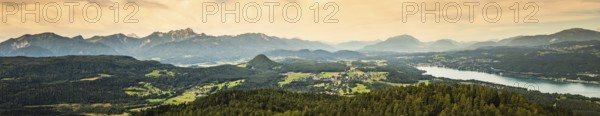 Panorama of Alpine mountains near Lake Worthersee and Velden city. Travel destination in Austria
