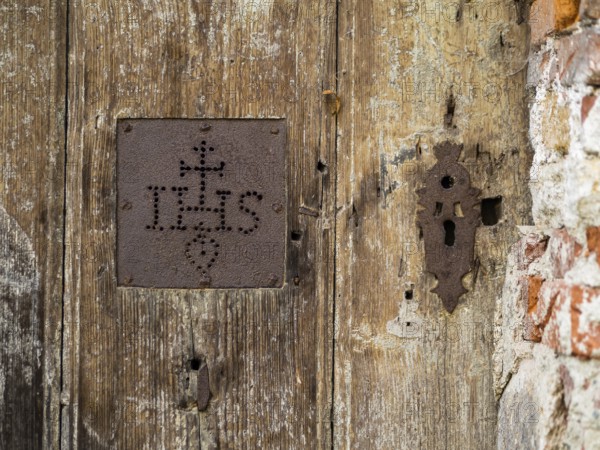 IHS, symbol of the Jesuits, detail of a gate, cemetery near the church of St. Jacob, Leoben,