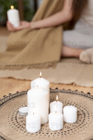 Woman meditating with tray with candles