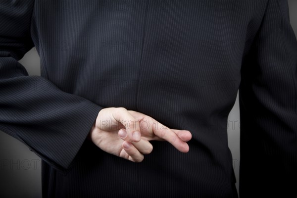 Crossed fingers behind the man's back