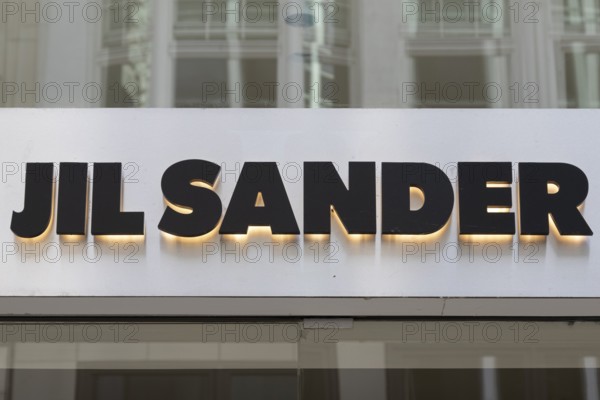 Close-up, logo of the German luxury fashion brand Jil Sander on a boutique in the shopping street