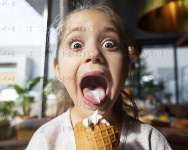 Surprised girl eating ice cream close up