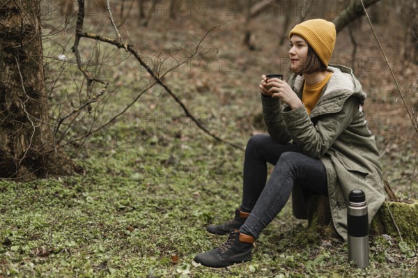Full shot woman sitting grass