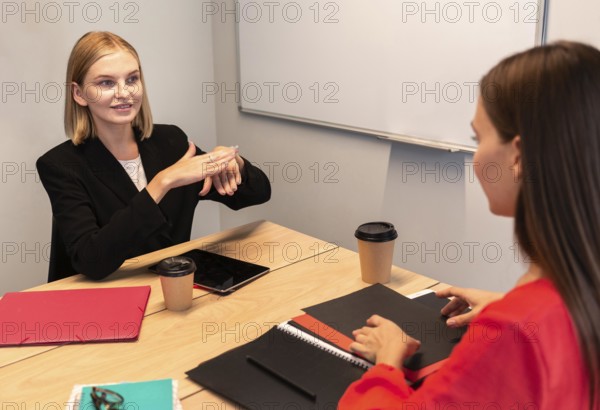 Businesswomen using sign language