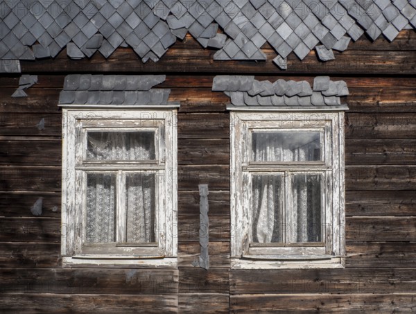 Weathered wooden windows with curtains on a wooden house with slates in the Vessertal, Breitenbach,