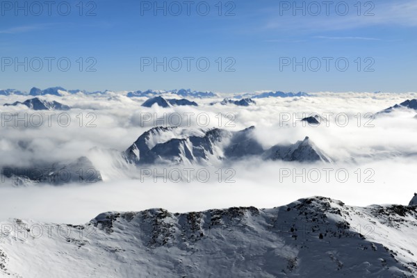 View from Wurmkogl, 3082 m, on the summit of the Oetztal Alps with clouds, behind peaks of the