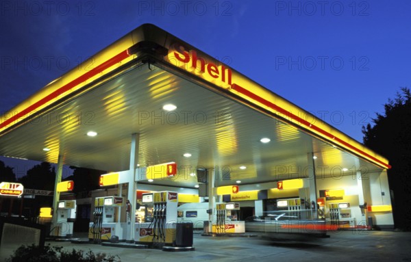 Shell Gas Station at sunset or night, a car entering, motion blur, Munich, Bavaria, Germany, Europe
