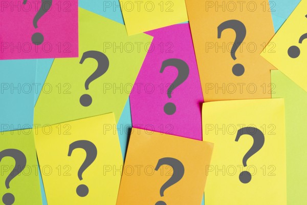 Question marks on colorful paper, looking for an answer, searching for knowledge, problem solving