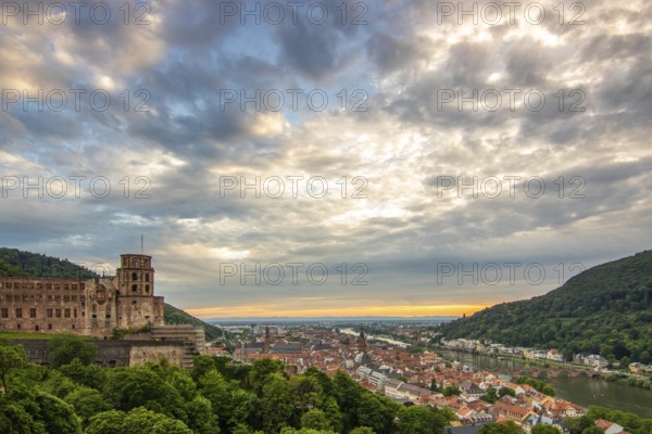 View over an old town with castle or palace rune in the evening at sunset. This town lies in a