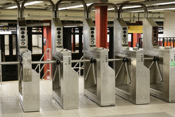 An empty underground station with rows of turnstiles, Manhattan, New York City, New York, USA,