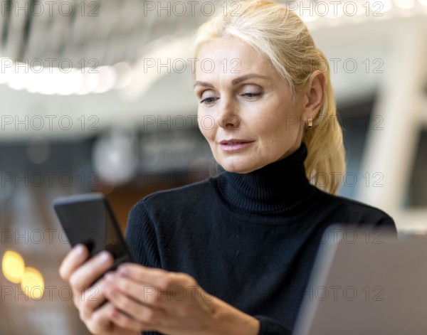 Front view elder business woman working laptop smartphone