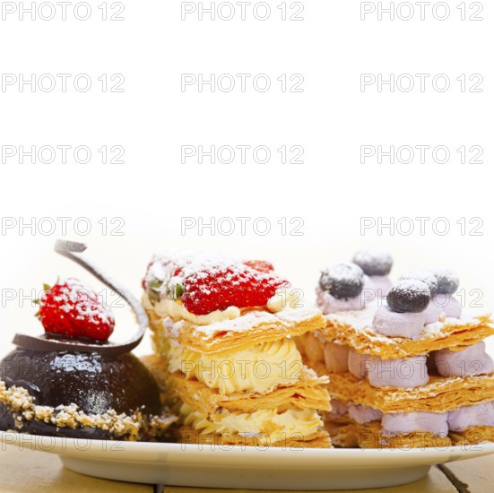 Selection of fresh cream napoleon and chocolate mousse cake dessert plate