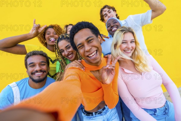 Transgender person gesturing peace while taking a selfie with multi-ethnic friends