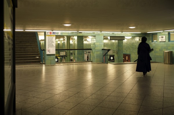 Germany, Berlin, 17. 09. 2020, Alexanderplatz underground station, lone woman, veiled in black,