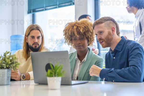 Close-up of concentrated coworkers using laptop in the office