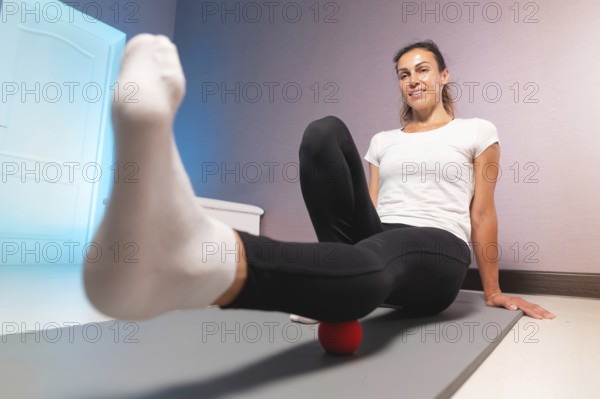 Young attractive woman doing exercises, wide angle view from below, indoor workout at home
