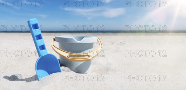 close-up view of toy bucket and spade on sand beach against sea and blue sky