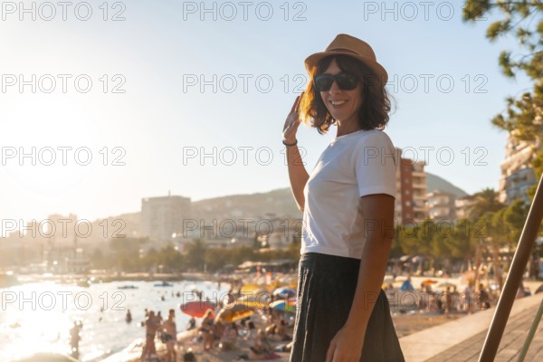 A tourist woman at sunset in Sarande or Saranda on the Albanian riviera, Albania, Europe
