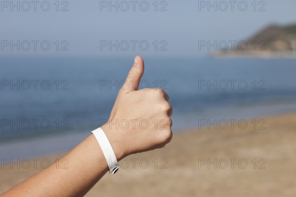 Summer vacations, woman hand gesturing thumb up success sign on sea sand beach