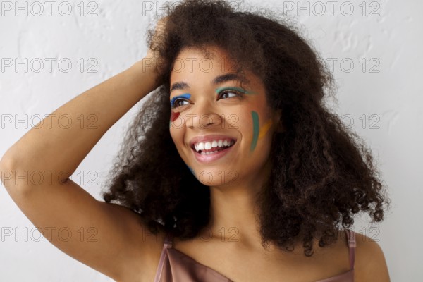 Beautiful happy african american ethnicity woman with creative art makeup looking aside with