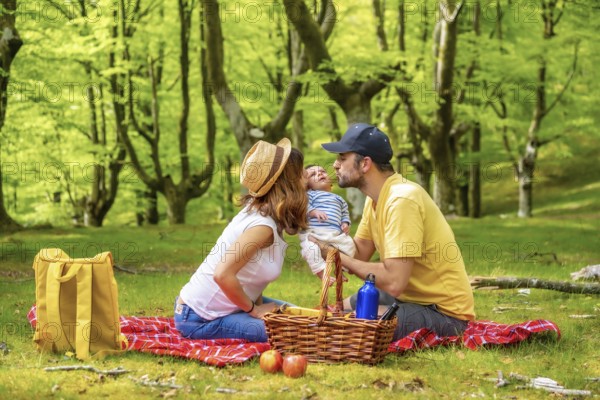 A picnic day with your newborn son. Dressed in white and yellow t-shirt, summer lifestyle of a
