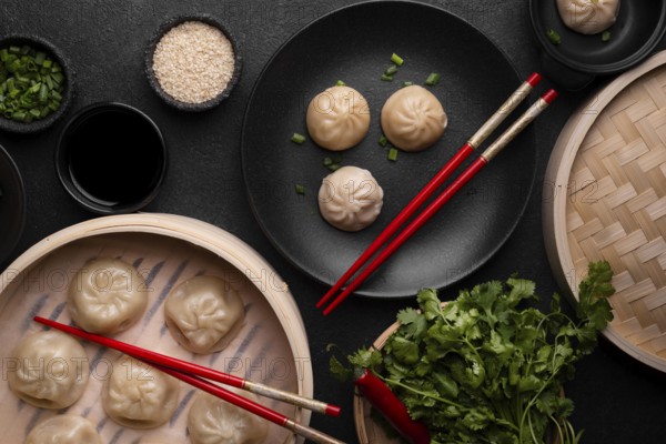 Top view asian dumplings with chopsticks herbs