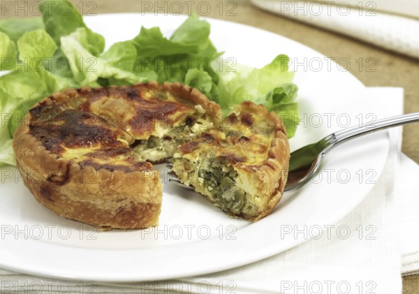 Leek quiche and salad on a plate