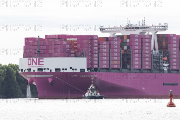 Pink container freighter One Innovation of the shipping company Ocean Network Express (Europe) Ltd.