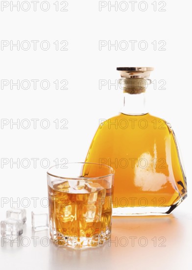 Front view whiskey bottle with glass