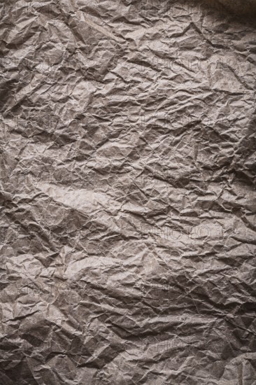 Ancient messy crumpled paper in vertical design