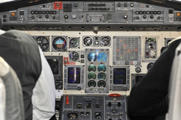 Close-up of a cockpit instrument panel with switches and screens, impressions of the great