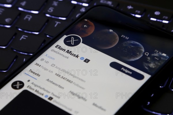 Symbolic image social media, close-up of a smartphone on illuminated computer keyboard with X logo