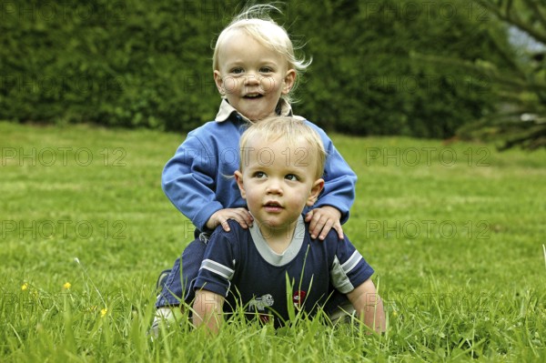 TWIN BROTHERS PLAYING ON GRASS