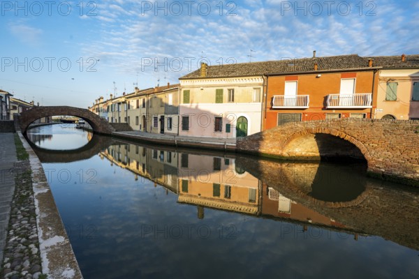 Houses and bridges reflected in the canal, Via Agatopisto Cromaciano, Comacchio, Emilia Romagna,