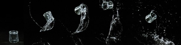 Glass of Water Bouncing and Splashing on Black Background