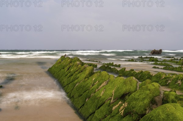 A long exposure view of Flysch rock formations at low tide at Barrika beach near Bilbao