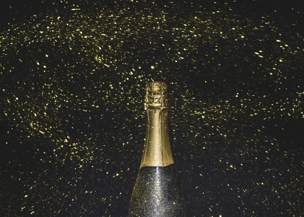 Bottle champagne flying golden glitters