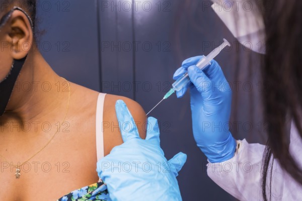 Detail of the vaccination in a black African ethnic girl, immunizes the population, people at risk,