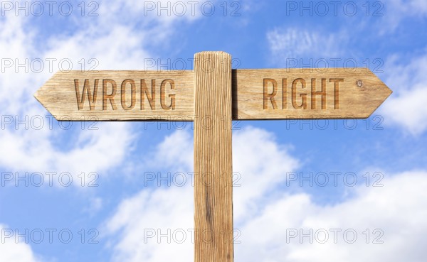 Wrong or right concept. Wooden signpost with message on sky background