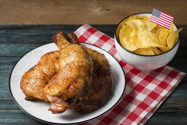 High angle chicken legs plate with chips