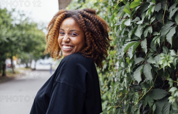 Close up photo of wavy hairdo charming cheerful dark skin person have good mood nice sightseeing