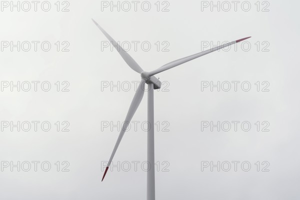 Wind turbine against cloudy sky