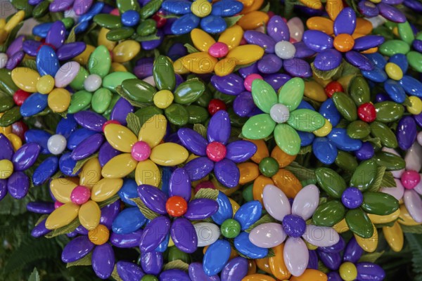 Colourful flowers made of confetti, shiny caramelised almonds, traditional sweet from Sulmona,