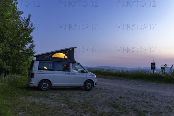 Camping with VW Bus T6.1 California, with pop-up roof and soft light, in hilly landscape, Oltingen,