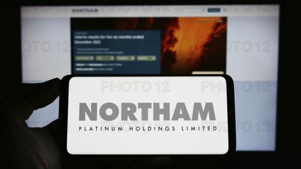 Stuttgart, Germany, 04-19-2023: Person holding cellphone with logo of company Northam Platinum