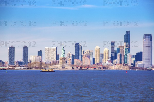 Statue of Liberty Statue of Liberty and behind it skyline of New Jersey City, seen from New York