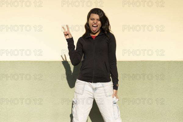 Teenage girl portrait .Expression of happiness, winning attitude and sticking out tongue