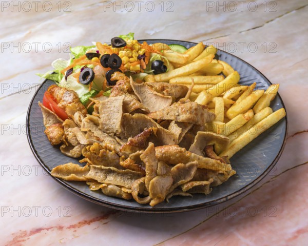 Chicken Shawarma plate with salad, fries served in a dish isolated on grey background side view of